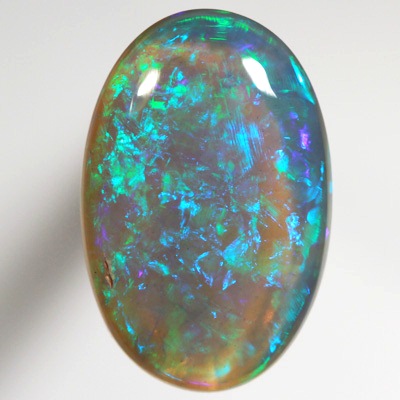 SOLID BLACK CRYSTAL OPAL Very bright greens over a purple hue SEE VIDEO